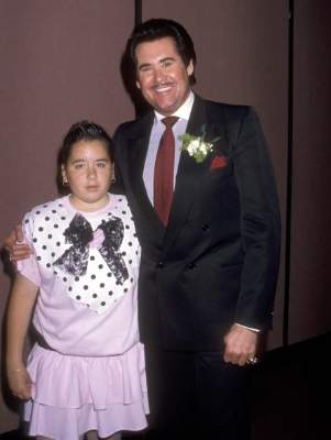 Elaine Okamura adopted daughter Erin Newton posing with her father, Wayne Newton.